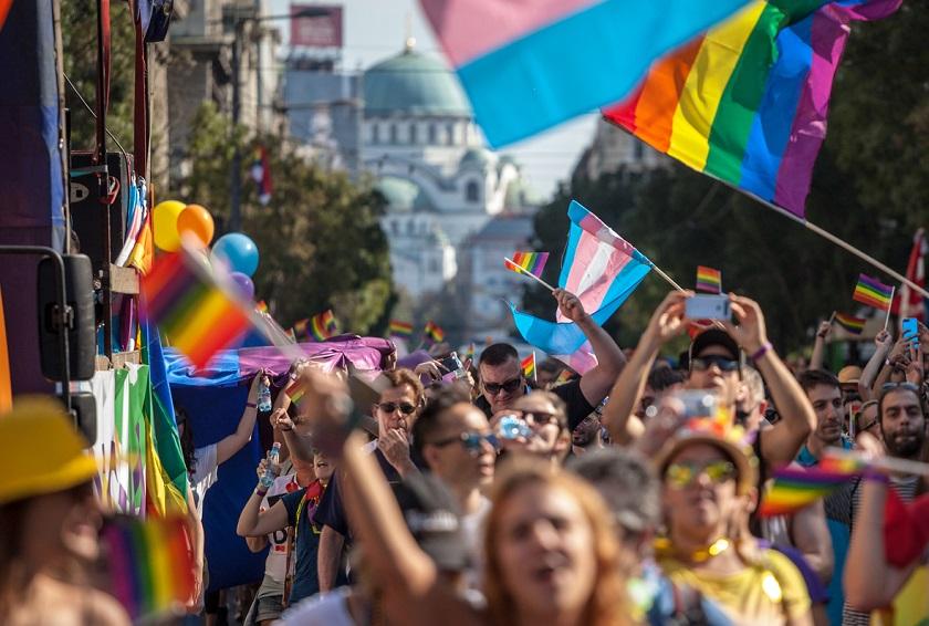 parade with rainbow and trans flags